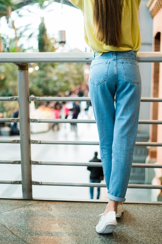 Woman in jeans at handrail